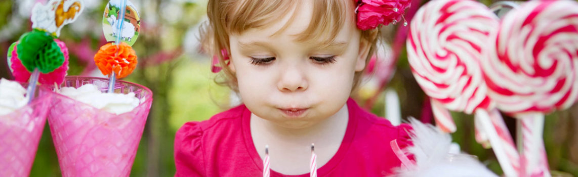 cute kid blowing a cake candle