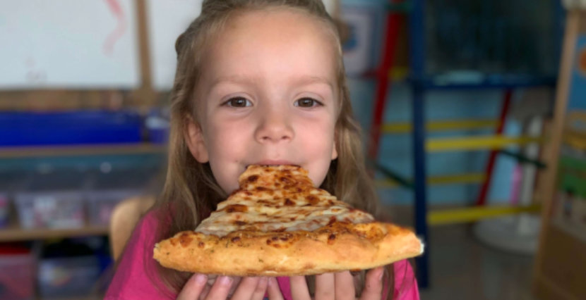 cute girl eating pizza